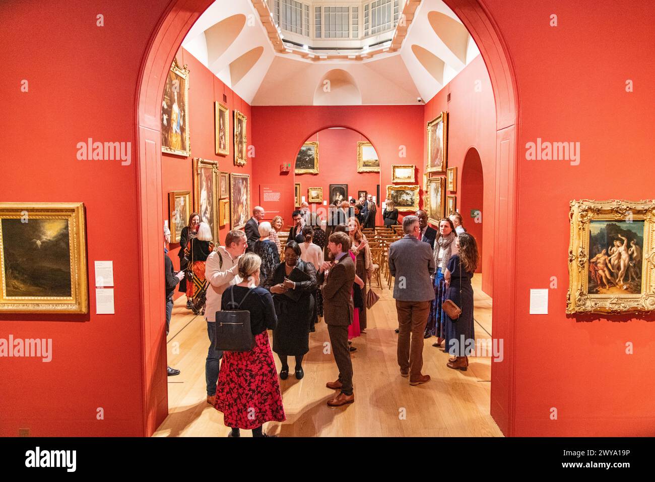 A crowd of wedding guests congregated in the main gallery of Dulwich Picture Gallery in London, UK Stock Photo