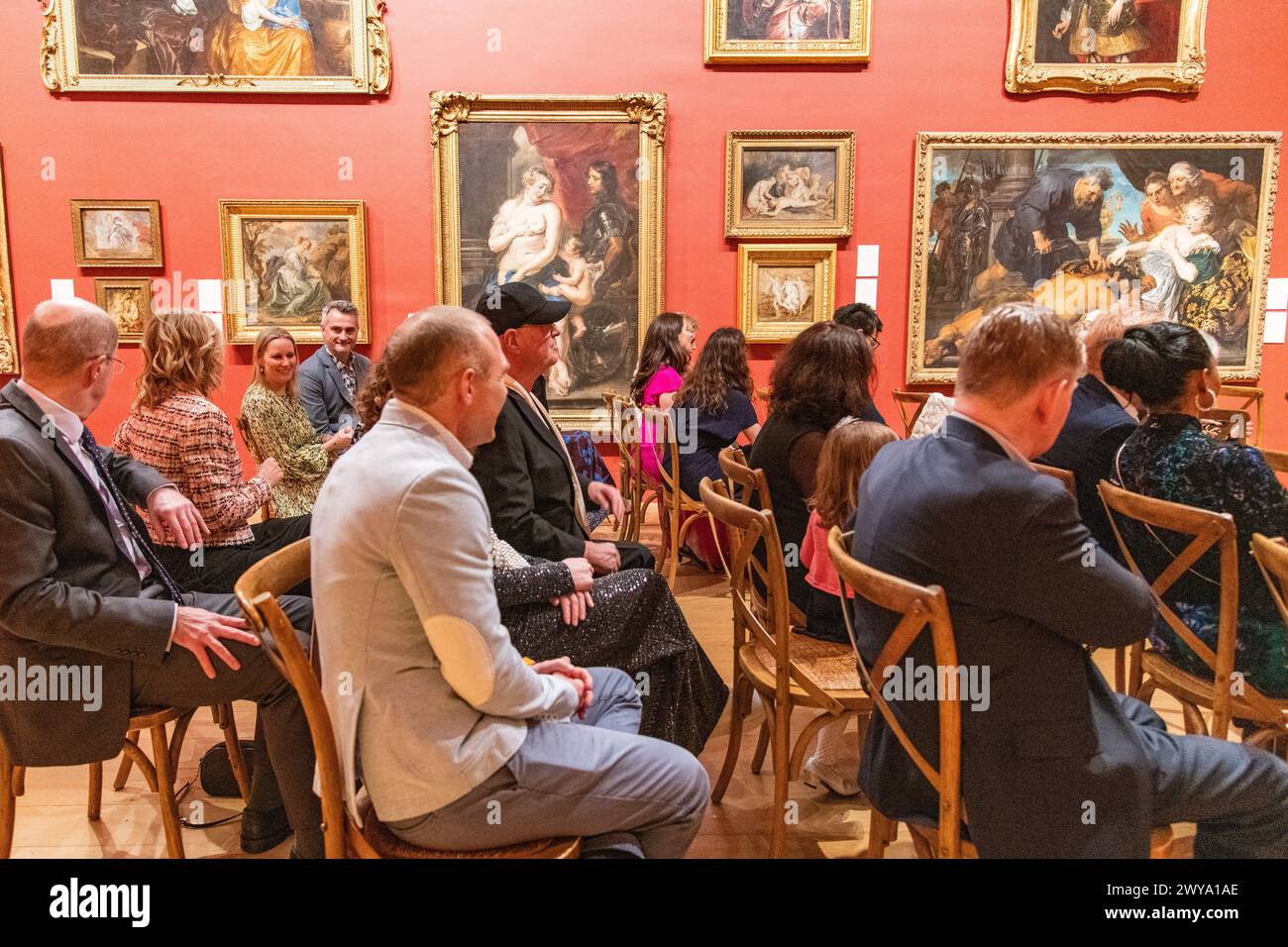 A wedding congregation of guests sitting during a wedding ceremony at Dulwich Picture Gallery in London, UK Stock Photo