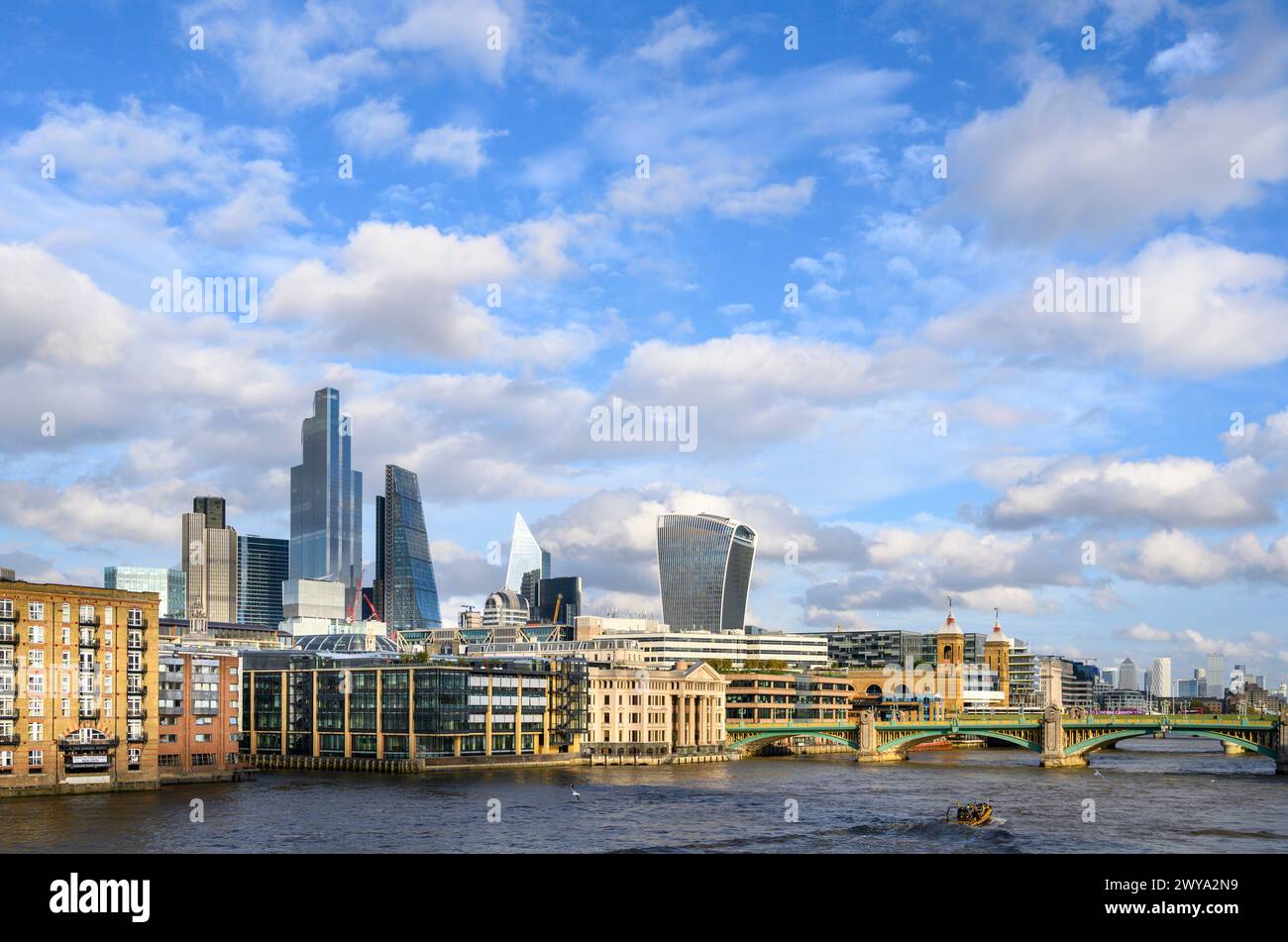 Riverside apartments next to the River Thames with buildings in the Bank district behind, London, England. Stock Photo
