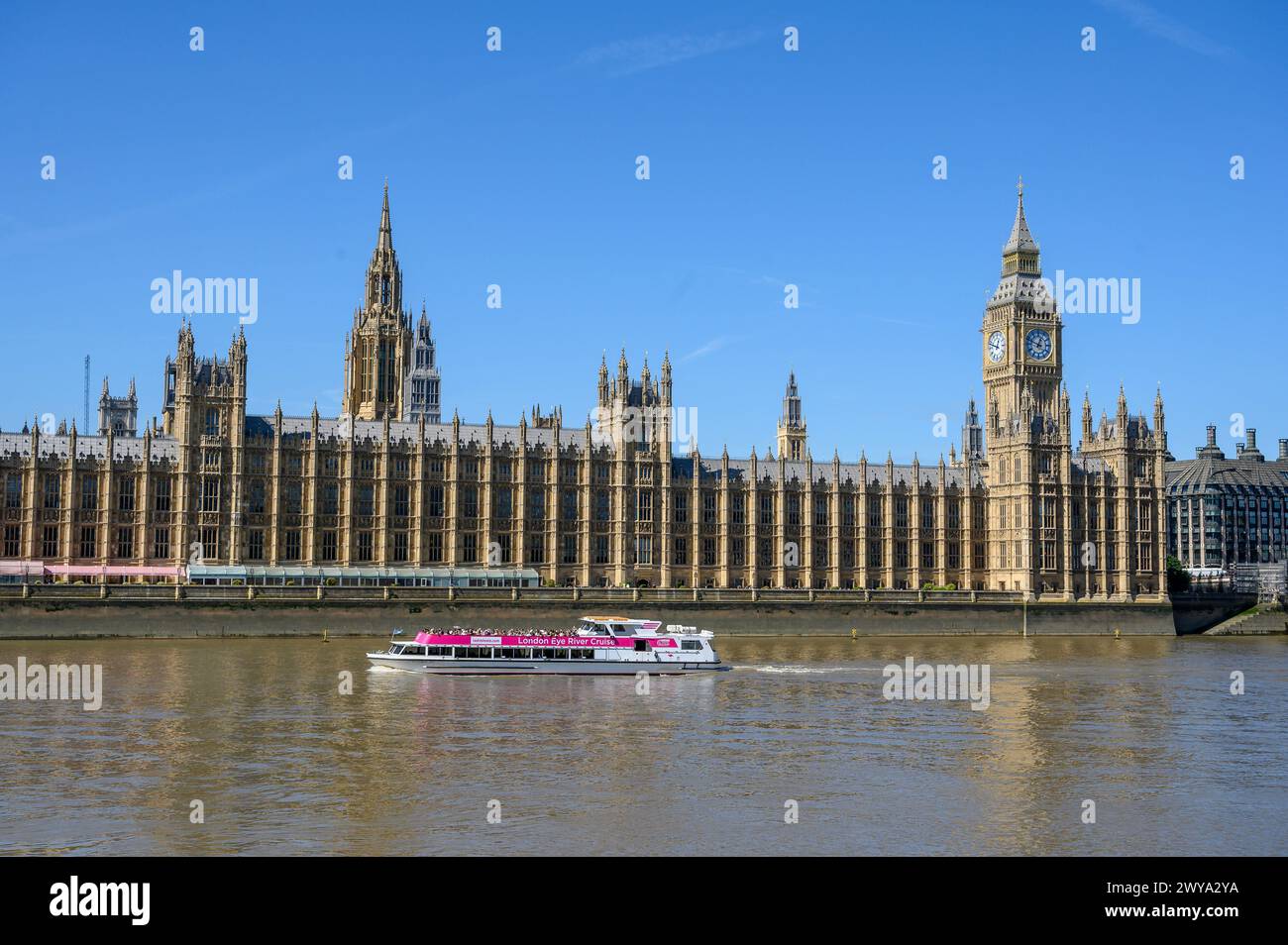 Tourist boat passing The Palace of Westminster, London, England. Stock Photo