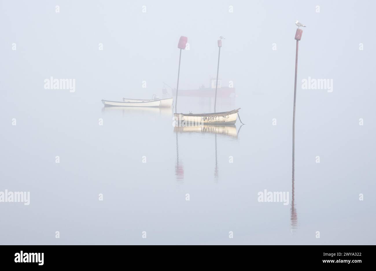 Boats in the fog with posts fine art pin mill Suffolk Stock Photo