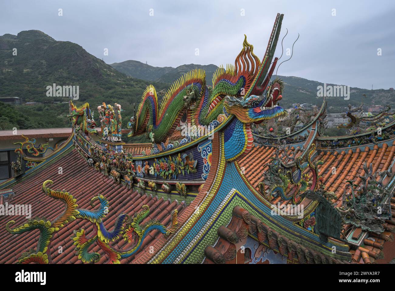 Wide-angle view showcasing a dragon-decorated Chuen Ji Hall temple roof Stock Photo