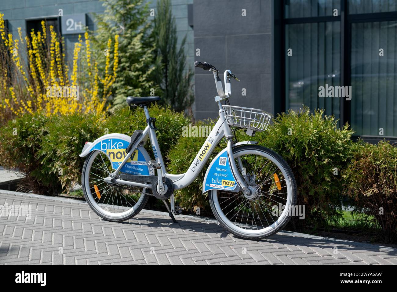 KYIV, UKRAINE - April 05, 2024. Urban bike is standing on the sidewalk. Bikenow. Ukrainian bike sharing service. Public bicycle in the parking lot. Pa Stock Photo