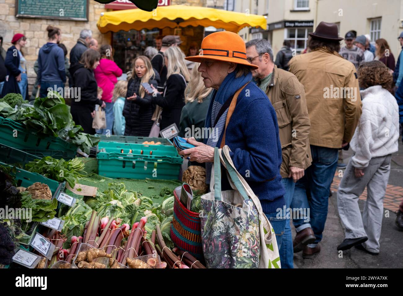 People buying vegatables from a fruit and veg stall at Stroud Farmers Market on 30th March 2024 in Stroud, United Kingdom. Stroud is a market town and civil parish in Gloucestershire, known particularly for its thriving farmers market which takes place every Saturday, specialising in the best local produce. Stock Photo