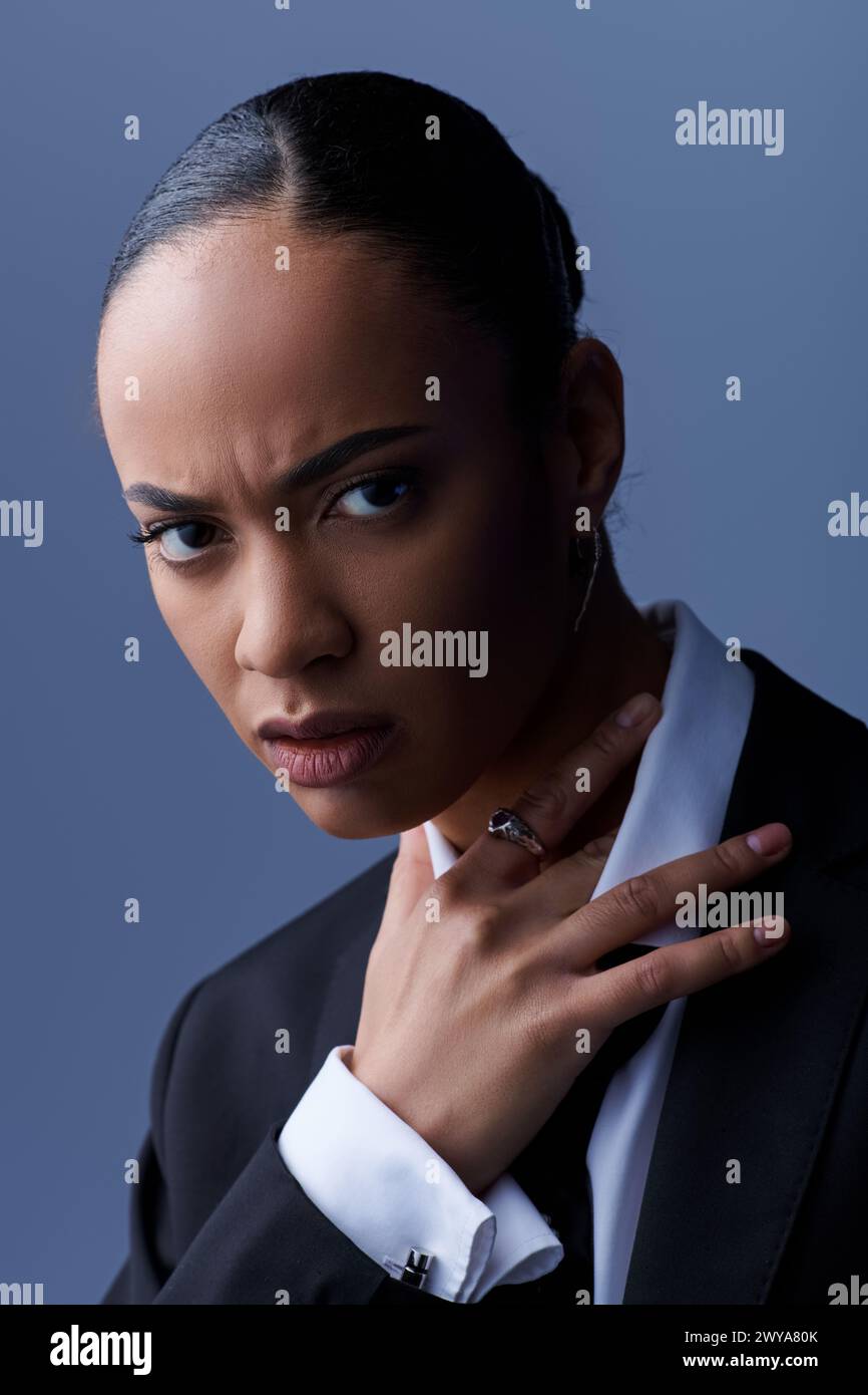 A young African American woman exudes confidence in a suit and tie ...