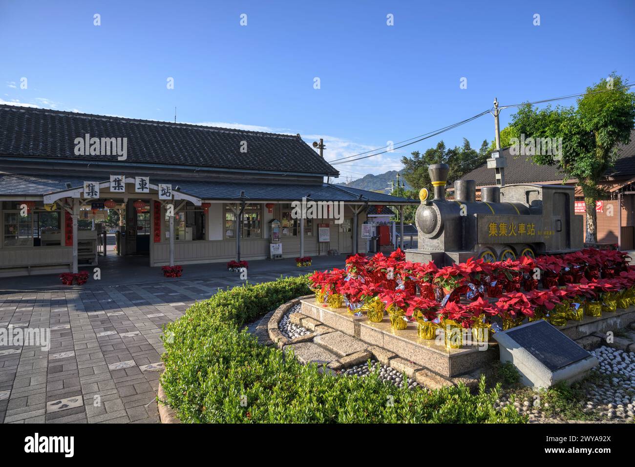 A deserted platform at Jiji railway station offering a nostalgic glimpse into the past with a scenic mountain backdrop Stock Photo