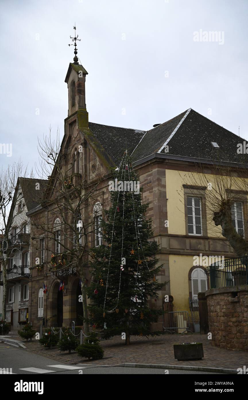 Landscape with scenic view of the local Town Hall exterior with festive Christmas decorations in Kintzheim, Alsace France. Stock Photo