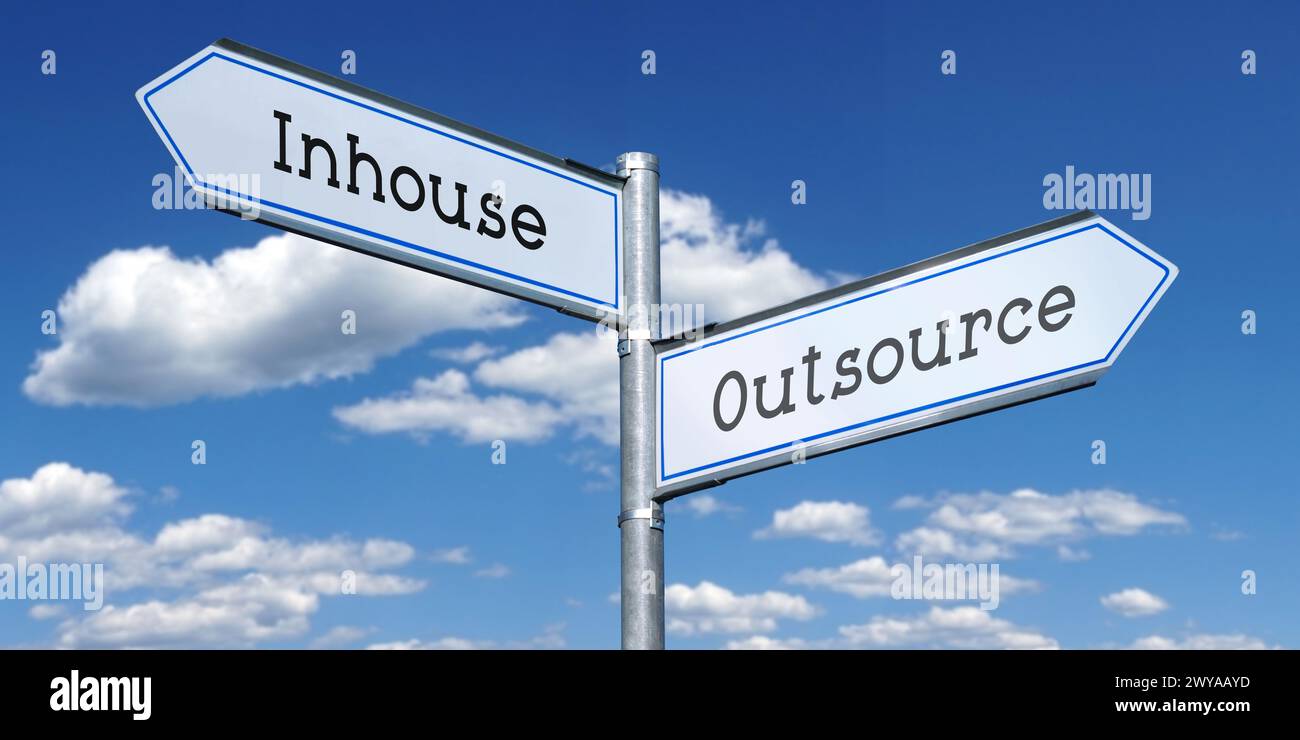 Outsource or inhouse - metal signpost with two arrows Stock Photo
