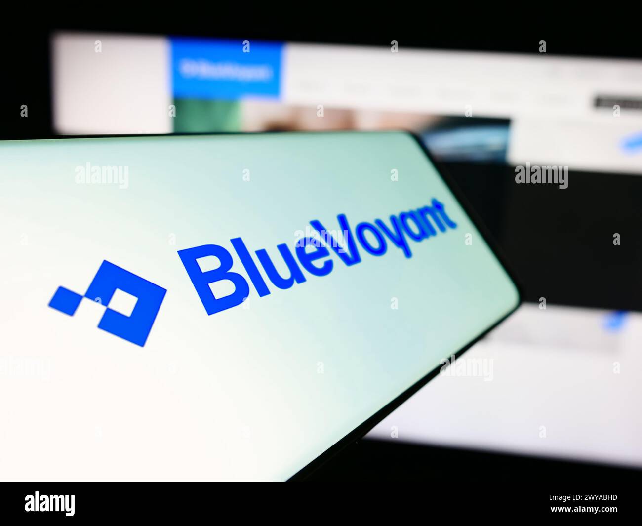 Mobile phone with logo of American cyber defense platform company BlueVoyant LLC in front of business website. Focus on left of phone display. Stock Photo