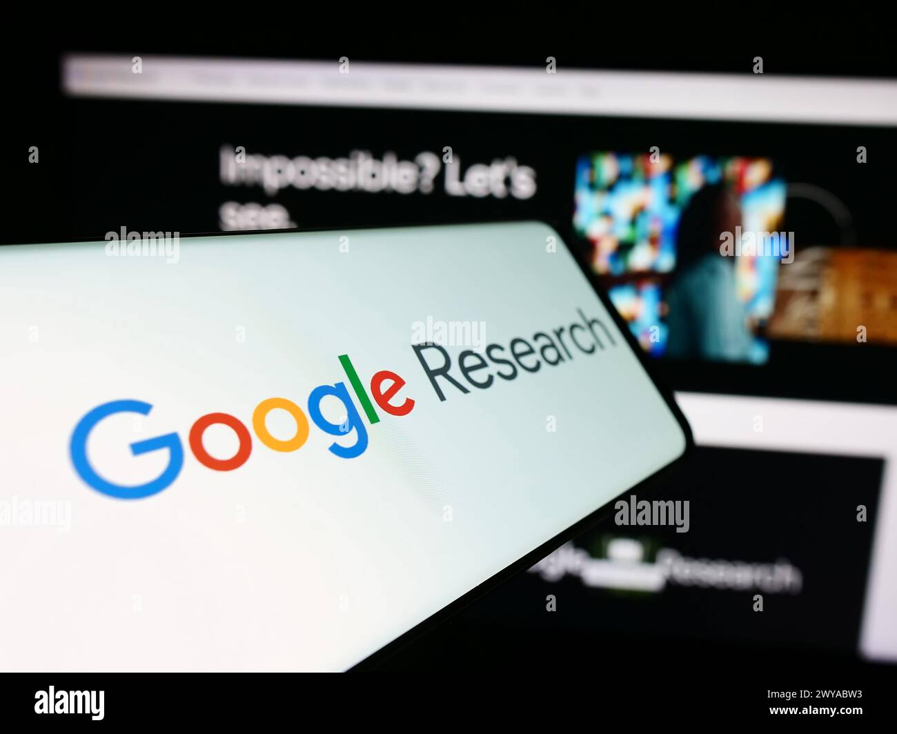 Mobile phone with logo of American technology company Google Research in front of business website. Focus on center-left of phone display. Stock Photo