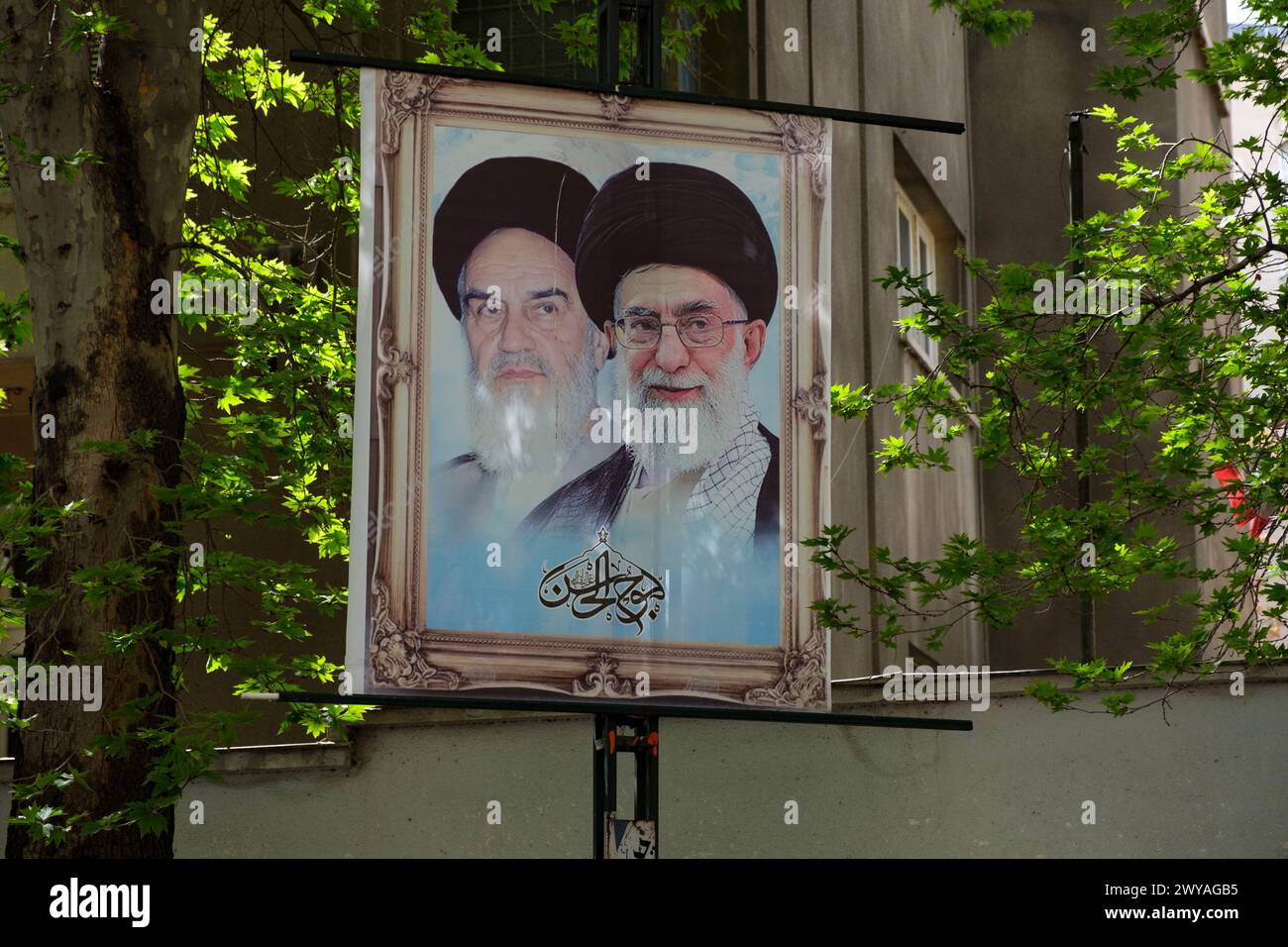 Ayatollah's photos hung on a rack. Islamic Republic of Iran establisher Ruhollah Khomeini on the left and the current leader Ali Khamenei on the right Stock Photo