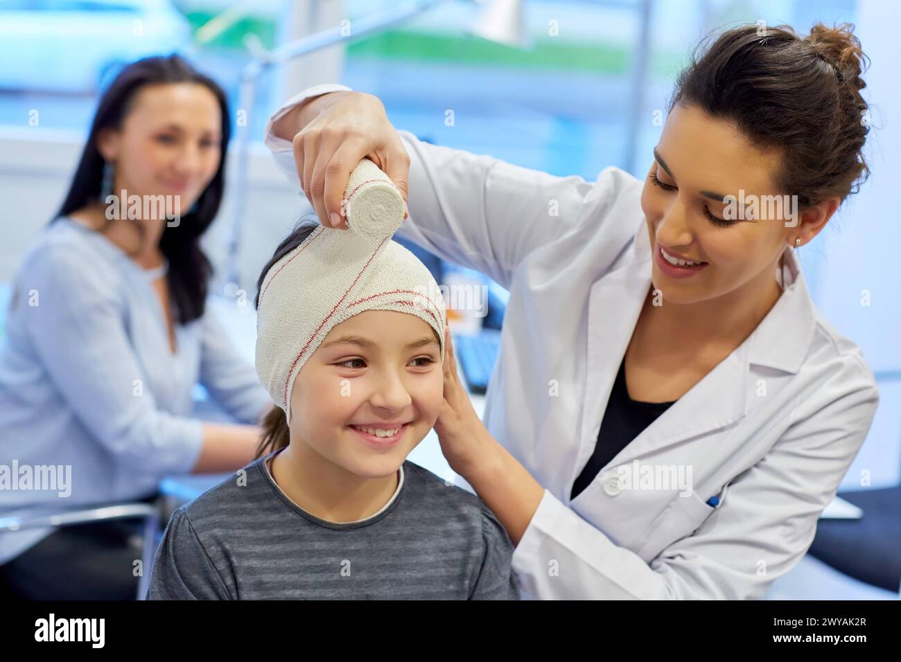 Otoplasty. winged ears. Malformation there is an absence antehelix crease. Otoplasty involves molding the ear cartilage to create a new fold. Doctor attending to patient medical consultation. Office. Plastic surgery. Pediatrician. Stock Photo