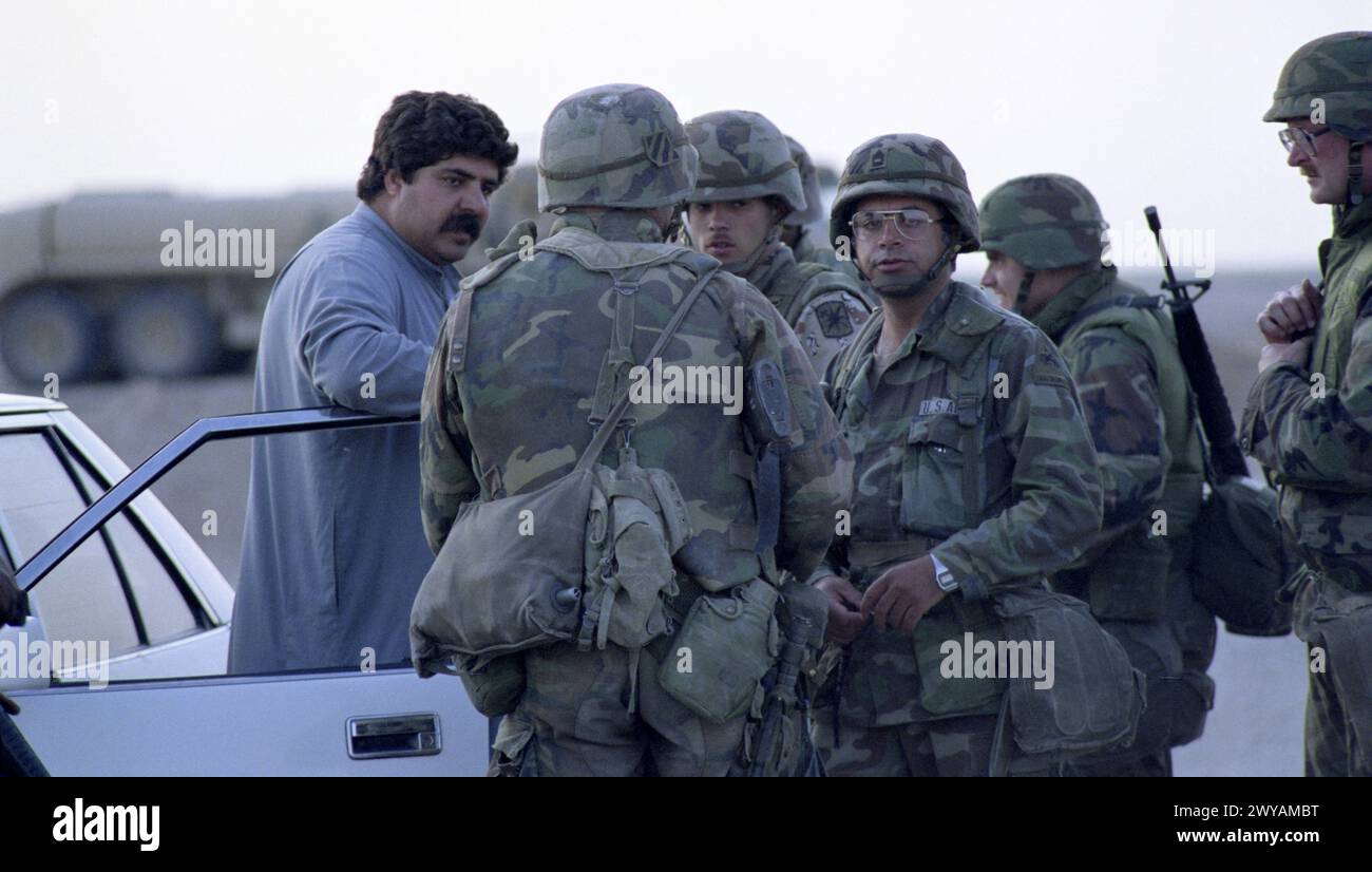 26th March 1991 U.S. Army soldiers talk with a local man at the last ...