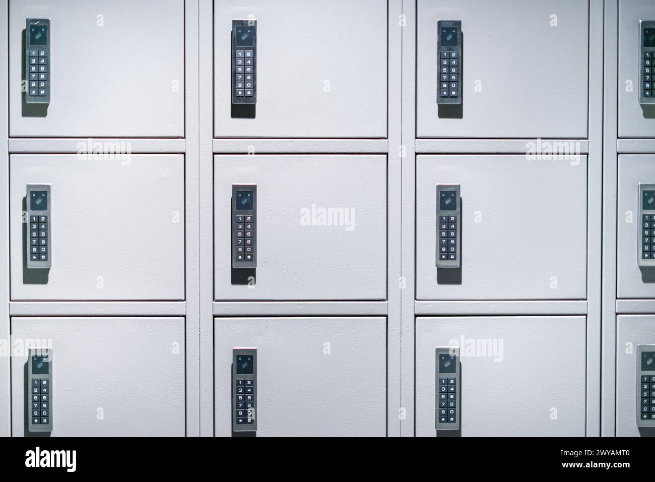 A row of closed gray cabinets equipped with a combination lock Stock Photo