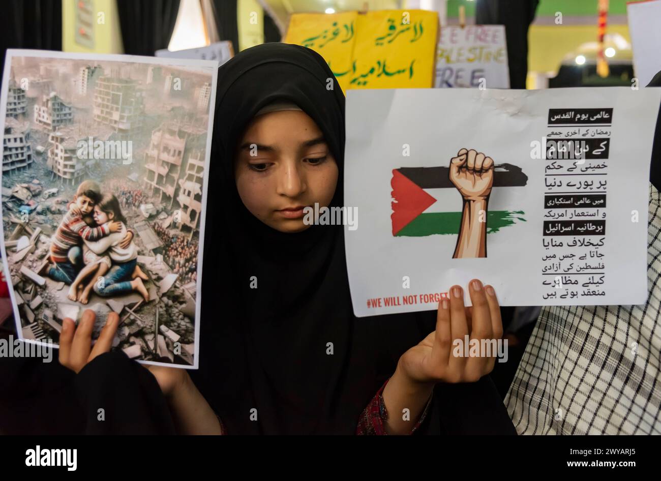 Srinagar, India. 05th Apr, 2024. A Kashmiri Muslim girl holds posters ...