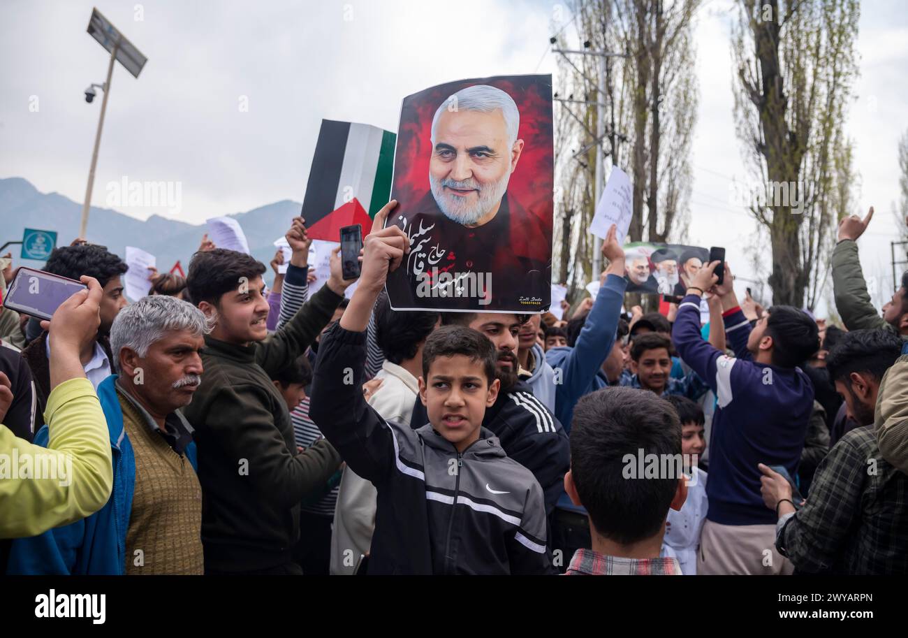Srinagar, India. 05th Apr, 2024. A Muslim boy hold a picture of Iranian general Qassim Sulaimani during a Pro-Palestinian rally marking Quds day. (Al-Qud) is the Arabic name For Jerusalem. An initiative started by the late Iranian revolutionary leader Ayatollah Ruhollah Khomeini, Al Quds Day is celebrated globally on the last Friday of the Holy month of Ramadan to show support for Palestinians and condemn Israel. Credit: SOPA Images Limited/Alamy Live News Stock Photo