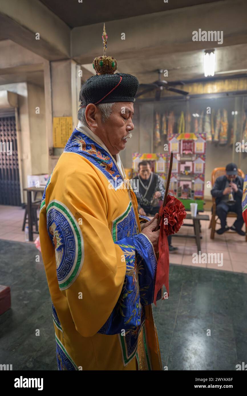 A traditional shaman performing a ritual with offerings to the ...