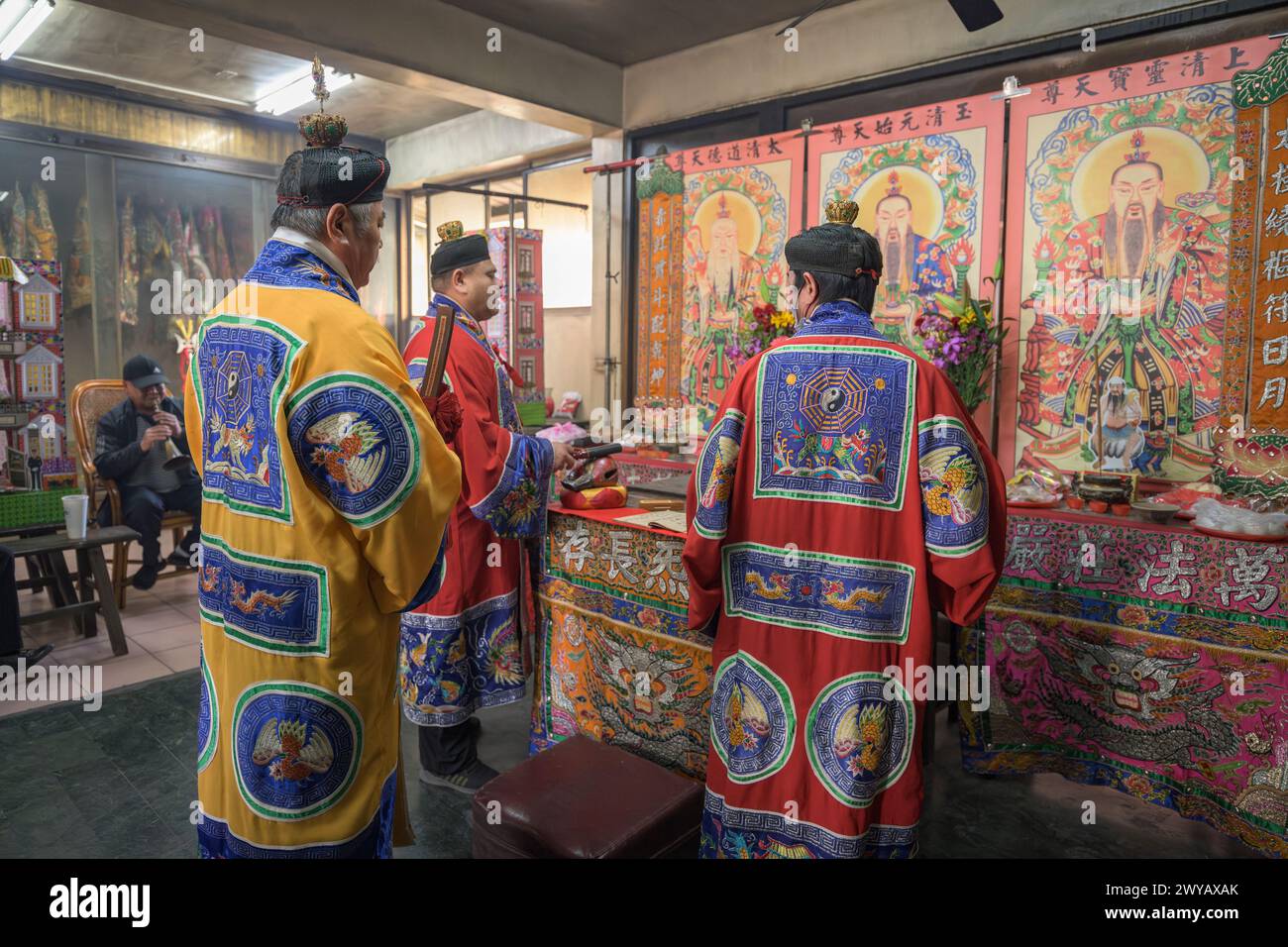 A traditional shaman performing a ritual with offerings to the ...