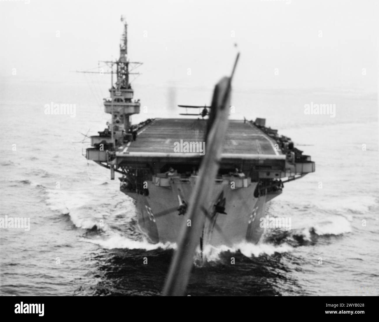 WITH THE ESCORT CARRIER HMS SMITER. 1944, AT SEA, ON BOARD A FAIREY SWORDFISH OF THE CARRIER DURING THE TRAINING OF DECK LANDING CONTROL OFFICERS, WHEN AIRCRAFT WERE TAKING OFF AND LANDING ON. - Looking back from a Fairey Swordfish as it took off from the SMITER. , Stock Photo