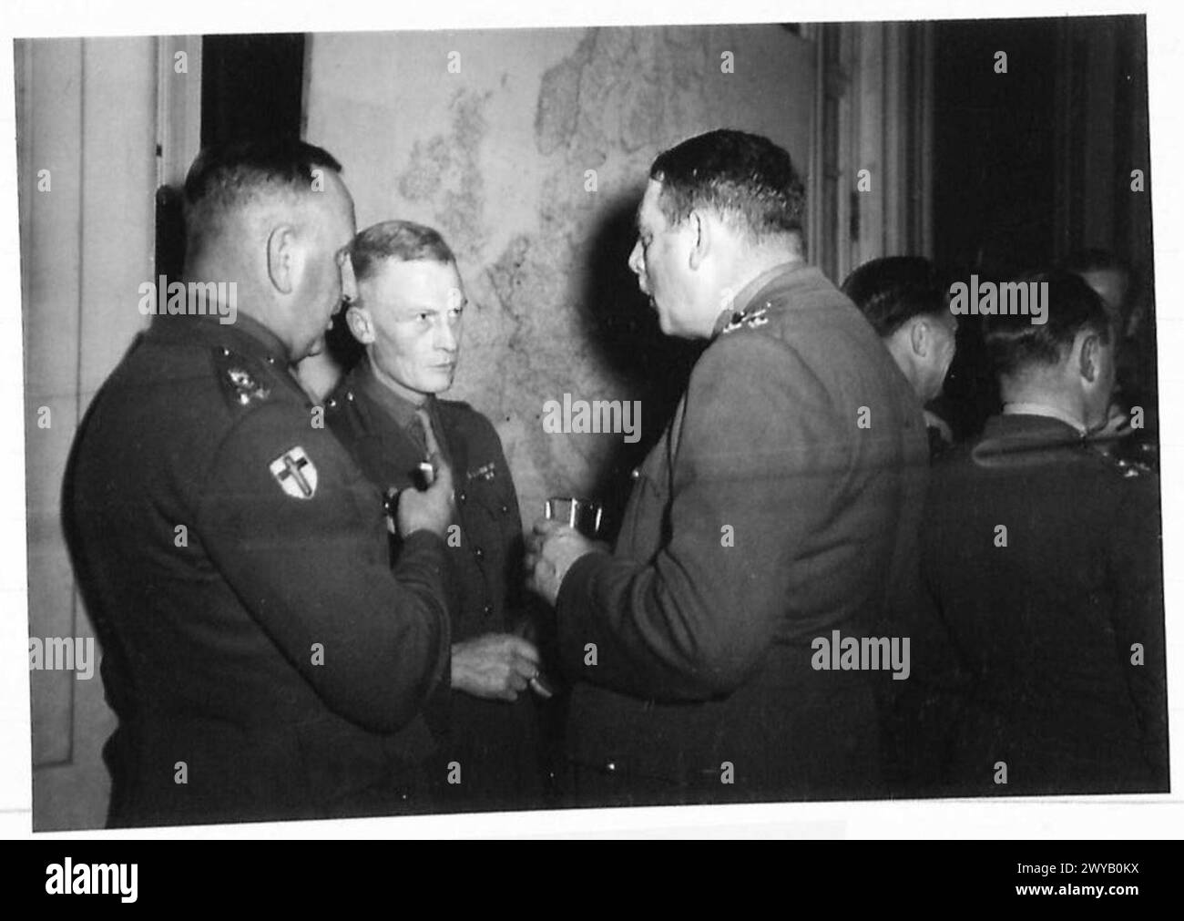 ALAMEIN DINNER - Original wartime caption: 17. Brig. R.H.R. Steward, DSO, OBE, MC. Brig. C. Knowles, OBE. Brig. Q.V.B. Wallace, OBE, MC. Photographic negative , British Army, 21st Army Group Stock Photo