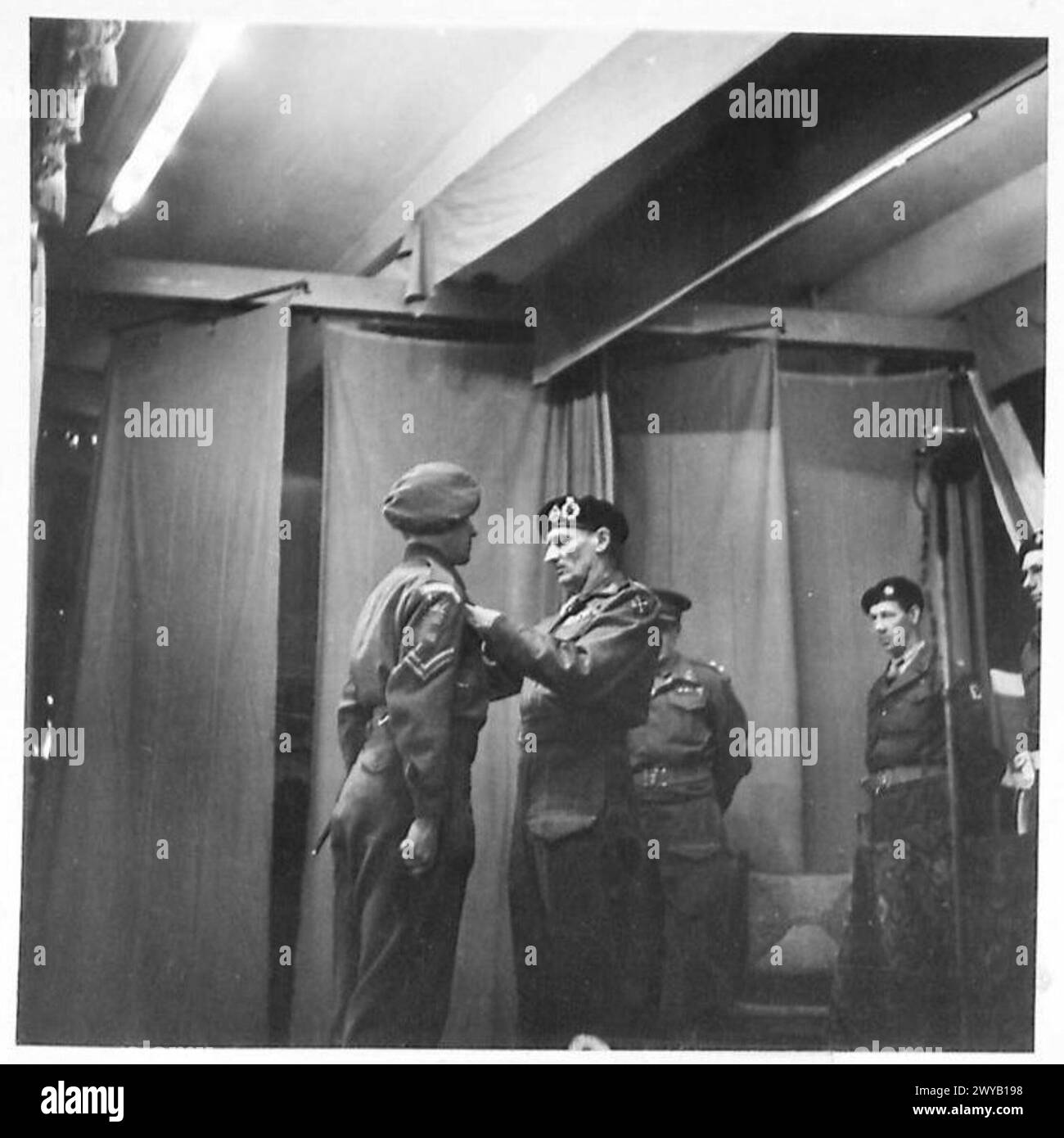 FIELD-MARSHAL MONTGOMERY AT INVESTITURE/53 (WELCH) DIV INVESTITURE AT ..., HOLLAND - Original wartime caption: Cpl. G. Evans, 4 Welsh Regt, receives the MM. Photographic negative , British Army, 21st Army Group Stock Photo
