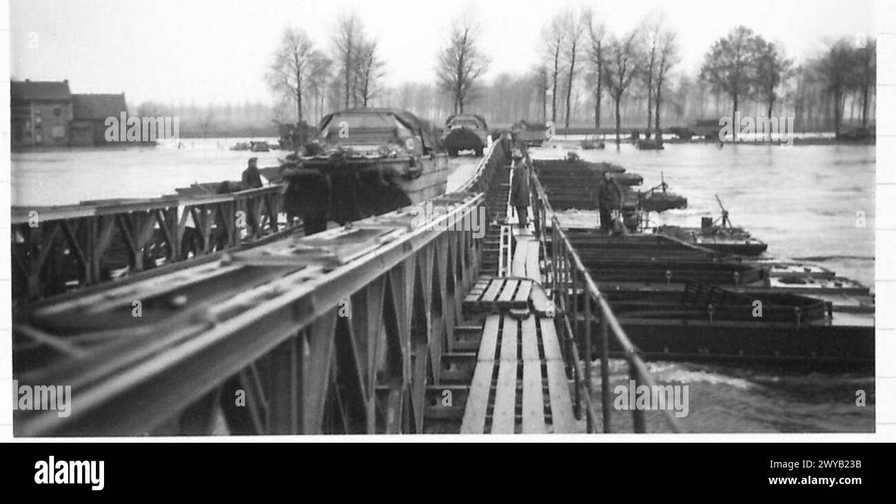 THE MAAS IN FLOOD NEAR MAESEYK - Original wartime caption: General view of the bridge with 'Ducks' passing over on their way to Germany. Photographic negative , British Army, 21st Army Group Stock Photo