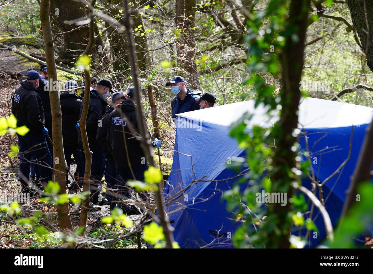 Police officers by a forensic tent at Kersal Dale, near Salford, Greater Manchester, where a major investigation has been launched after human remains were found on Thursday evening. Greater Manchester Police (GMP) said officers were called by a member of the public who found an "unknown item wrapped in plastic". Picture date: Friday April 5, 2024. Stock Photo