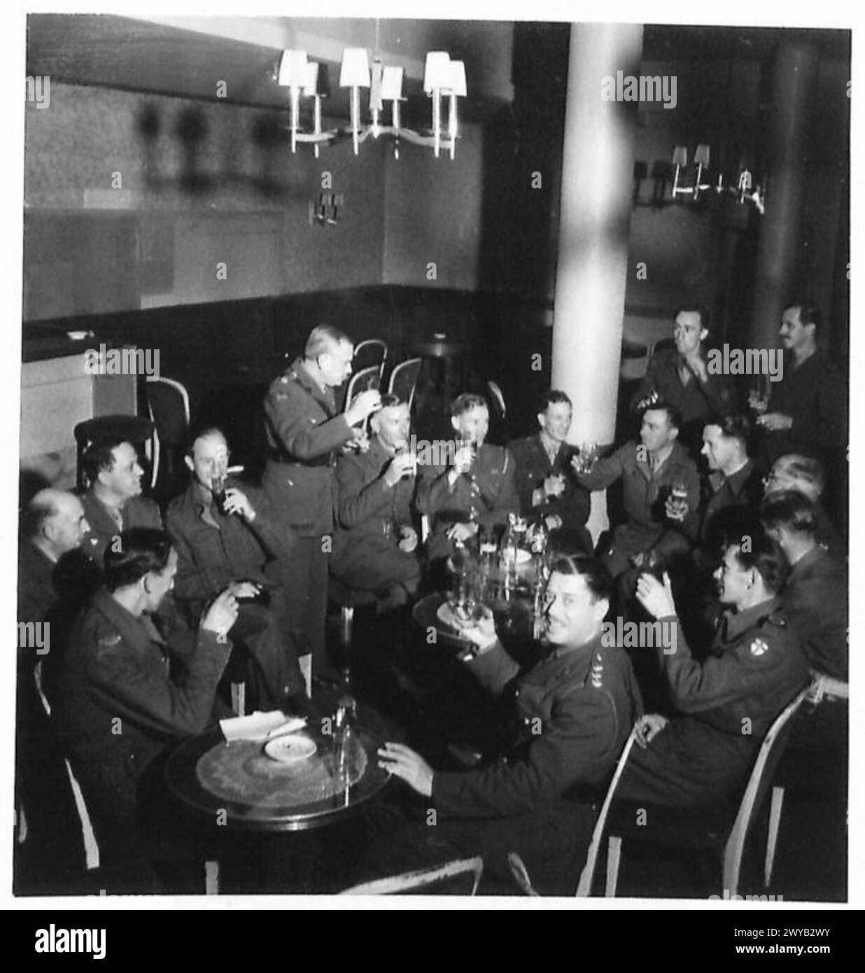 FIRST N.A.A.F.I. IN BERLIN - Original wartime caption: Group of N.A.A.F.I. officers with Press Correspondents. Photographic negative , British Army, 21st Army Group Stock Photo