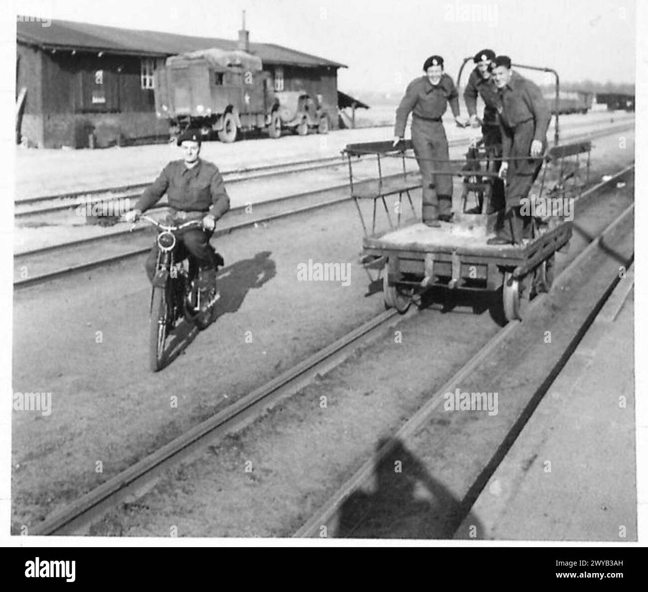 MILITARY GOVERNMENT IN BRUCHHAUSEN-VILSEN AND SYKE - Original wartime caption: At Bruchhausen-Vilsen, British troops used a rail trolley to convey them from billets to mess place, while one has a captured motorcycle. Photographic negative , British Army, 21st Army Group Stock Photo