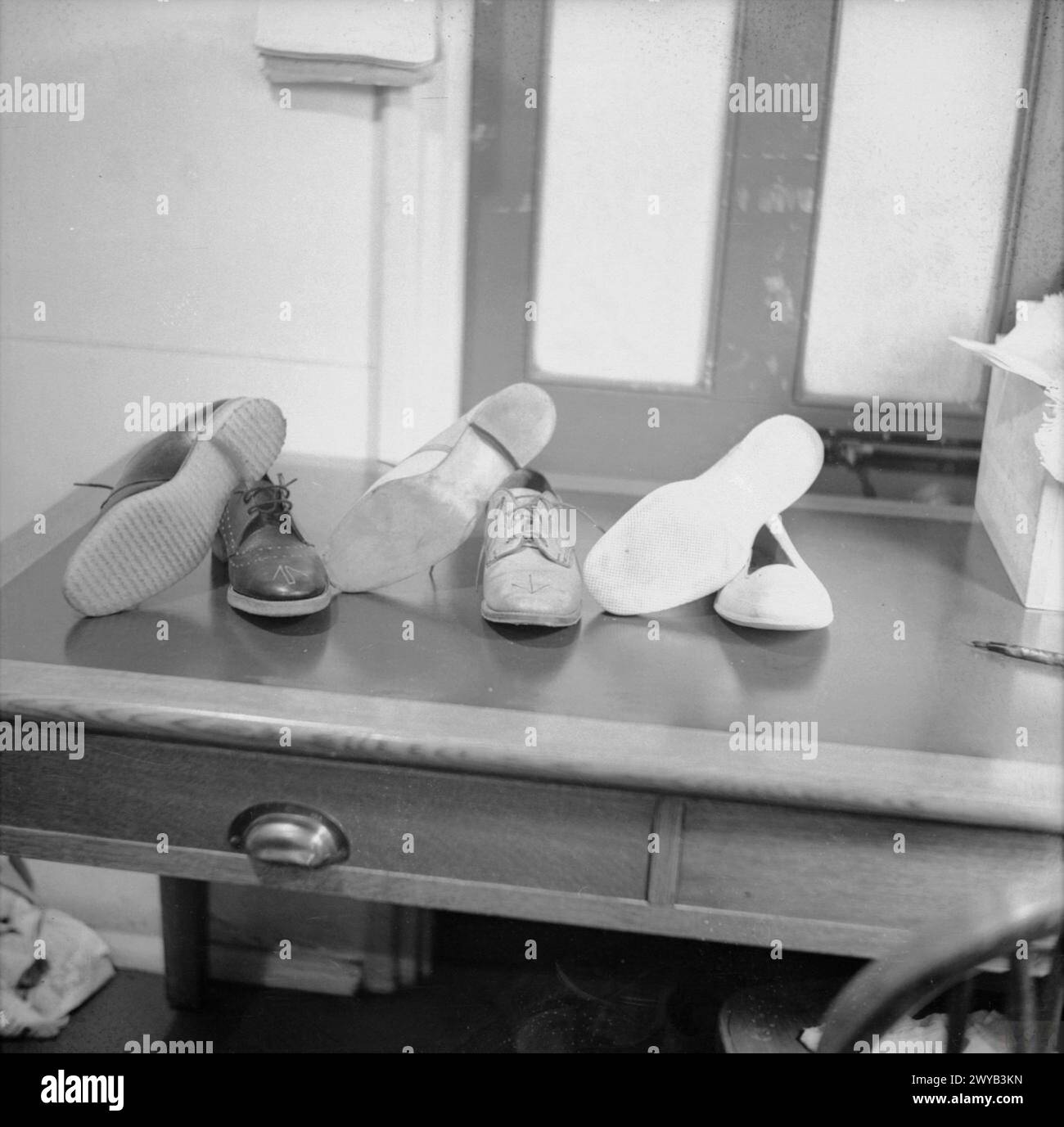MUNITIONS PRODUCTION IN BRITAIN, 1940 - This photograph shows the special shoes which must be worn within a munitions factory. They are made from leather or rubber and have no metal on them at all. It is important that these shoes are worn so that no sparks are generated by any metal fastenings: clearly, this would be disasterous in an arms factory. , Stock Photo
