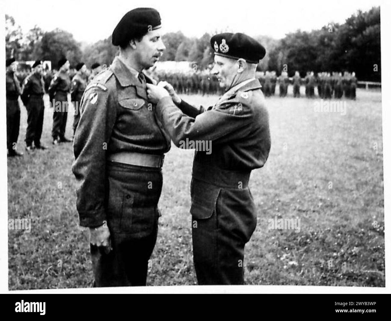 INVESTITURE CEREMONY FOR MEN OF THE 6TH GUARDS ARMOURED BRIGADE - Original wartime caption: Lieutenant Colonel the Lird Tryon, 4th Tk.Greandier Gds. receives the D.S.O. from the C-in-C. Photographic negative , British Army, 21st Army Group Stock Photo