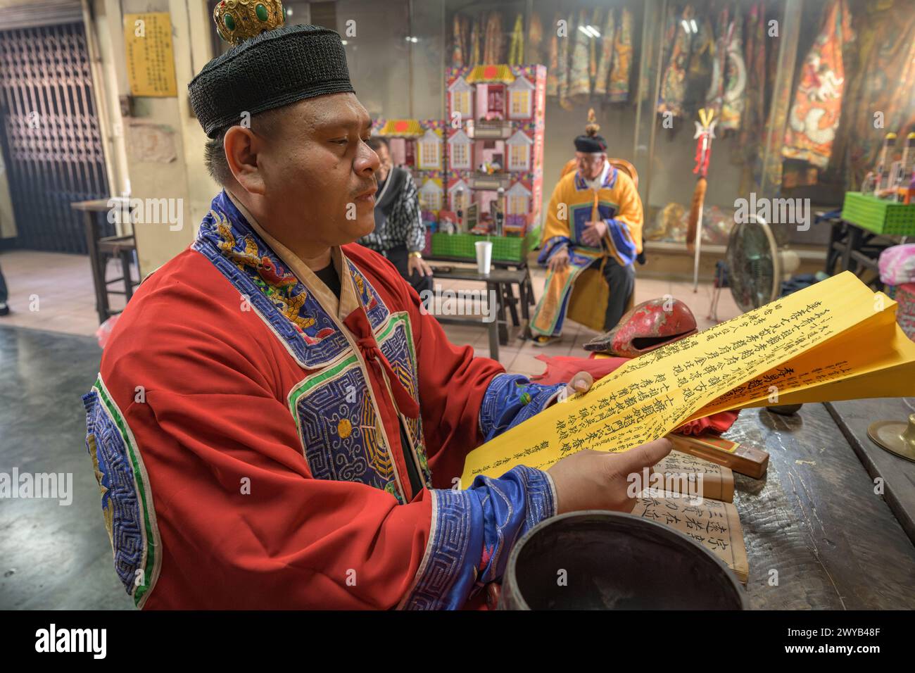 A traditional shaman performing a ritual with offerings to the ...