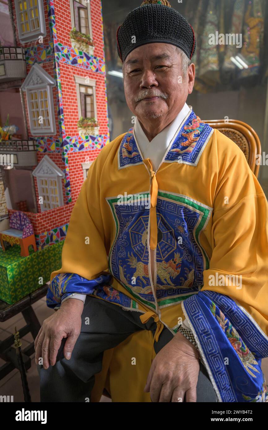 Portrait of atraditional priest in traditional outfit with ceremonial regalia smiling at the camera Stock Photo
