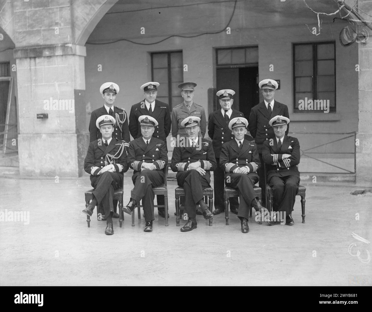 ADMIRAL SIR WILBRAHAM FORD AND HIS STAFF BEFORE HE LEFT MALTA TO BECOME C IN C ROSYTH. 1941, MALTA. - Admiral Sir Wilbraham Ford with a group of Naval Officers at Malta. Left to right: back row: Lieut Cdr W H B Wallace; Lieut Cdr H R B Howell; Major O E Haworth-Booth, RM; Lieut Cdr G Finley-Day; Commander M J Evans. Front Row: Pay Cdr R H Johnson; Captain G W Wadham, Chief of Staff; Admiral Sir Wilbraham Ford, KCB, KBE; Eng Captain H E Lewis; Commander P H Calderson. , Stock Photo