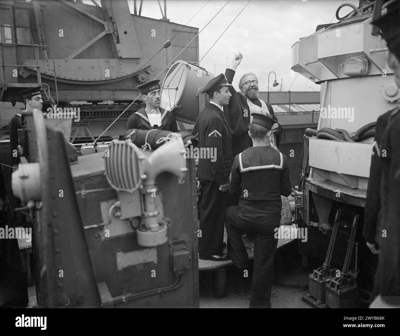 ARCHIMANDRITE BLESSES NEW GREEK DESTROYER THEMISTOCLES. 11 JULY 1943, NEWCASTLE. THE GREEK DESTROYER HHMS THEMISTOCLES IS BLESSED BY THE ARCHIMANDRITE, REV FATHER VIRVOS, ON COMMISSIONING. - Holy water being sprinkled on the bridge during the ceremony of blessing the ship. , Stock Photo