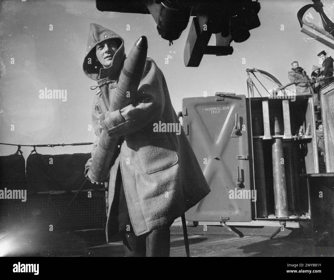 In 1940, aboard HMS Kelvin, a gunner is shown preparing to load a shell ...