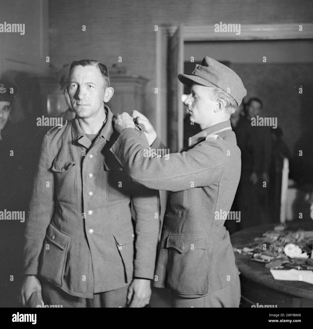 GERMANY UNDER ALLIED OCCUPATION - During the demobilisation process at No.1 Disbandment Control Unit, with no civilian clothes available, German soldiers are allowed to keep their uniforms after first having all badges of rank and decorations removed. , German Army (Third Reich) Stock Photo