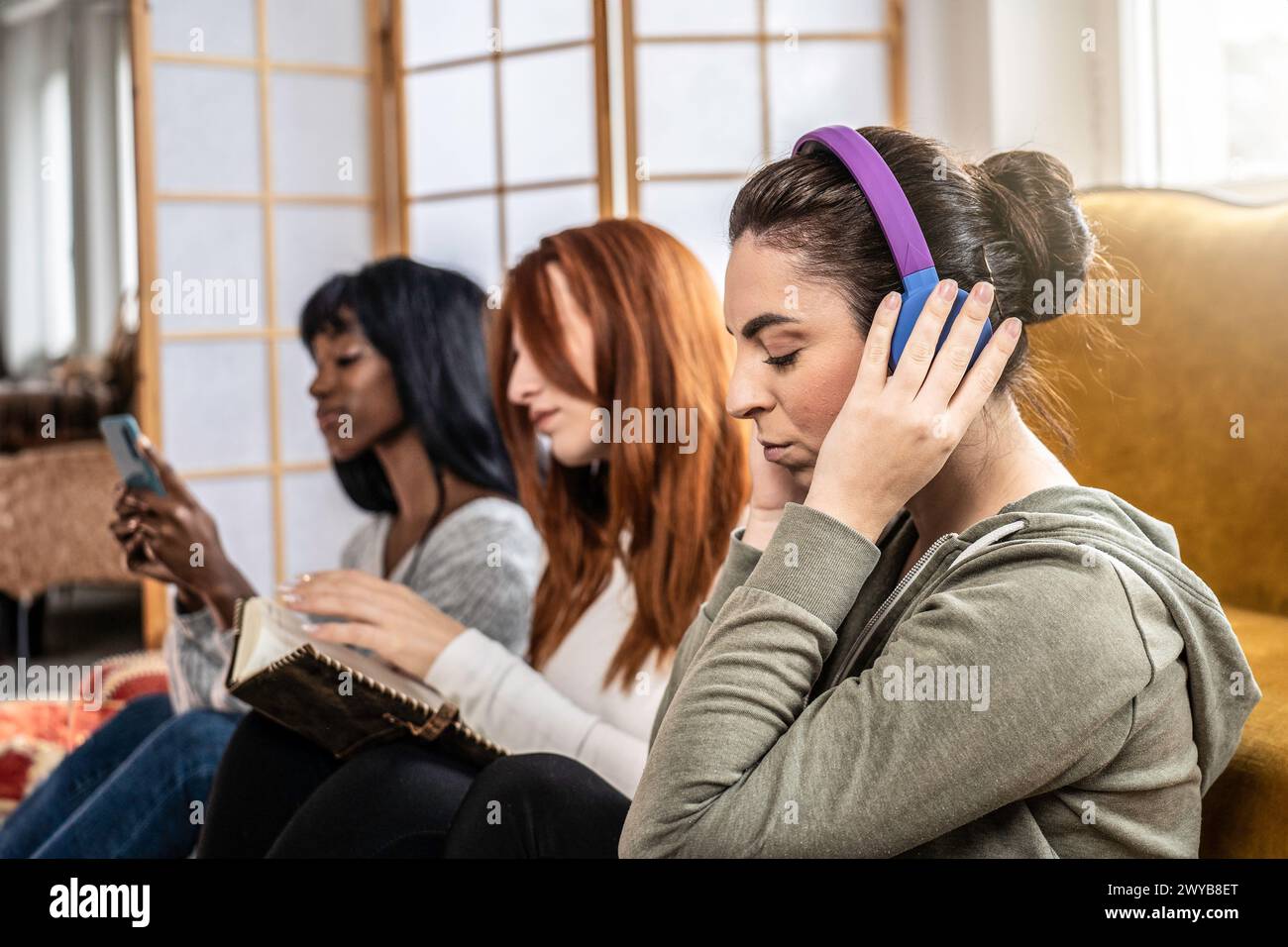 Women friends connected yet independent. A vibrant depiction of millennial and generation Z leisure in a tech-savvy world. Stock Photo
