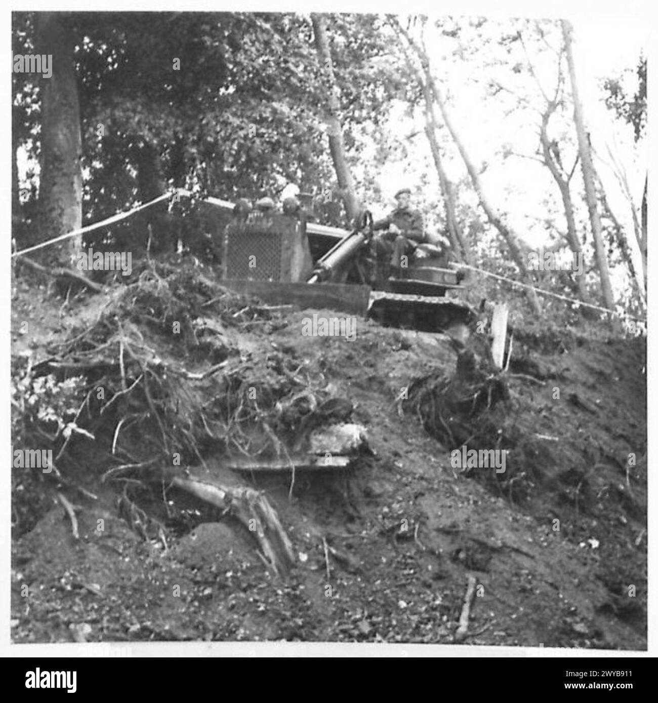 THE BRITISH ARMY IN NORTH-WEST EUROPE 1944-1945 - Original wartime caption: A bull-dozer at work. These mechanical miracles can work in almost impossible places. Photographic negative , British Army, 21st Army Group Stock Photo