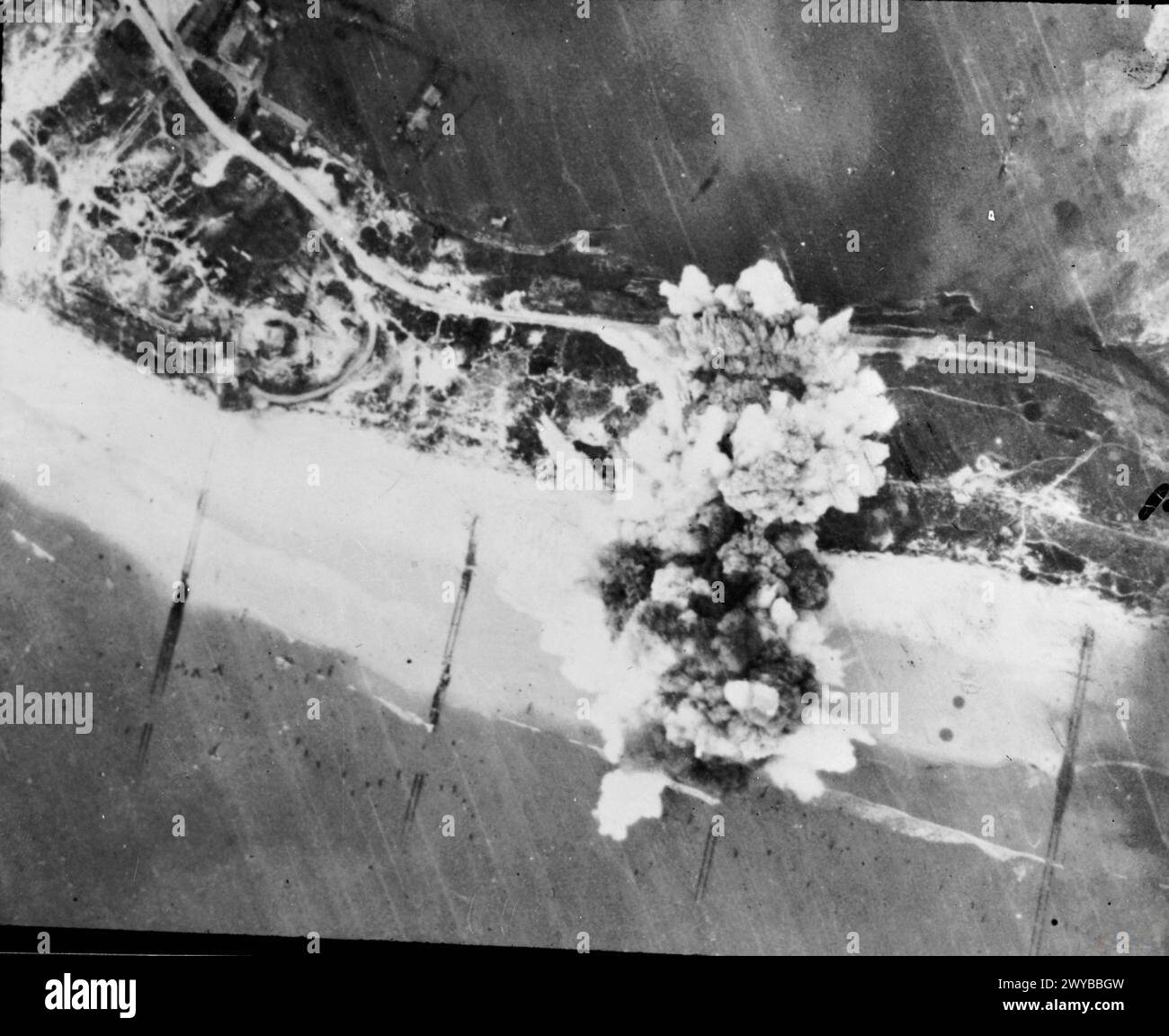 THE POLISH AIR FORCE IN THE NORTH-WEST EUROPE CAMPAIGN, 1944-1945 - What the Spitfire dive-bombers could do. Explosions straddle German flak positions close to the shoreline on Walcheren Island, 30 October 1944.This attack, carried out by Spitfire XVIs of one of the squadrons of the No. 131 (Polish) Wing, was part of a sustained 'softening-up' campaign by No. 84 Group and the bomber forces in advance of an amphibious assualt on the fortified island. , Polish Air Force, 131 Polish Fighter Wing, Royal Air Force, Group, 84 Stock Photo