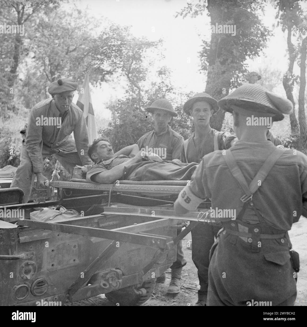 THE BRITISH ARMY IN ITALY 1944 - A casualty is placed on a jeep at a ...