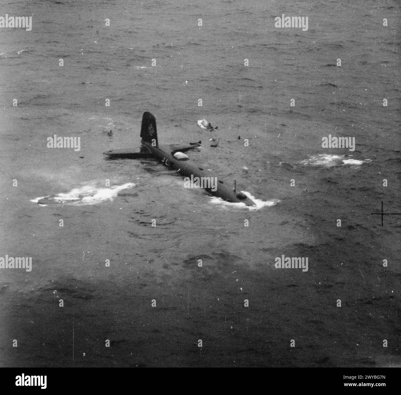 THE BATTLE OF ATLANTIC, 1939-1945 - A Focke-Wulf Fw 200 Kondor sinking in the Atlantic Ocean west of Ireland, after being shot down by a Lockheed Hudson Mark V of No. 233 Squadron RAF based at Aldergrove, County Antrim, while trying to attack a convoy, 23 July 1941.This oblique aerial photograph was taken from the victorious Hudson (AM536) and shows the crew of the Kondor swimming for their liferaft which is inflating to the right of the tailplane. , Royal Air Force, Maintenance Unit, 235, German Air Force (Third Reich) Stock Photo