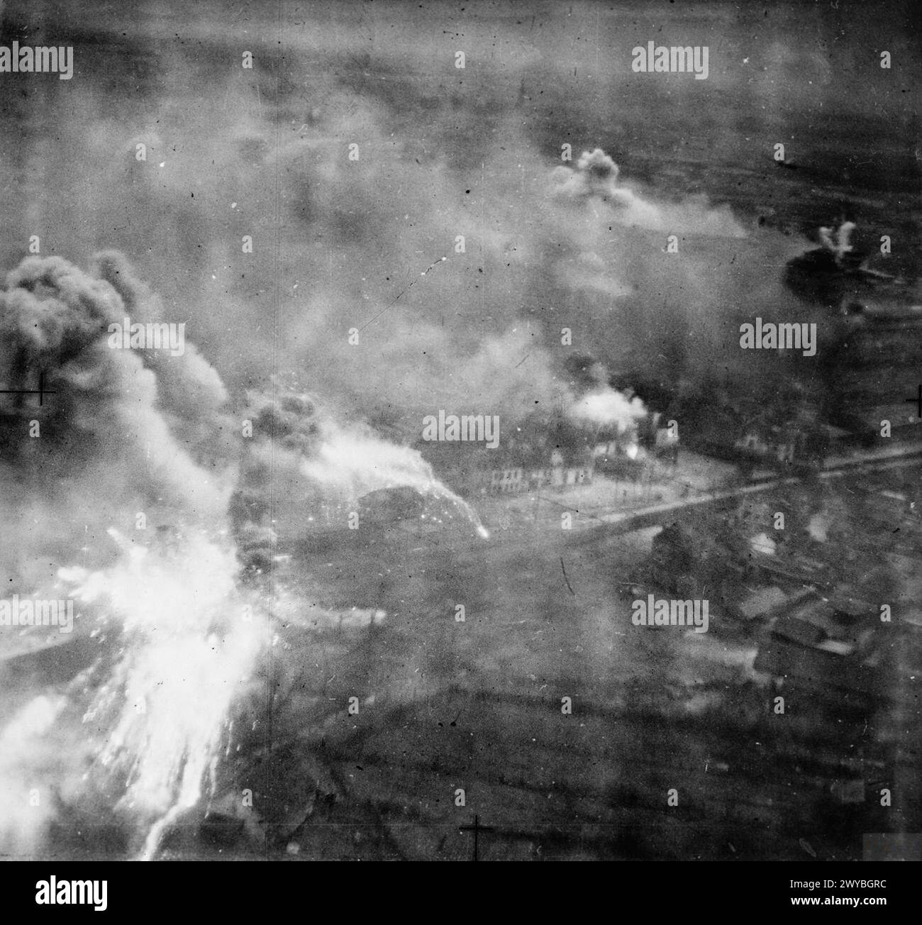 ROYAL AIR FORCE BOMBER COMMAND, 1942-1945. - Operation OYSTER, the daylight attack on the Philips radio and valve works at Eindhoven, Holland, by No. 2 Group. Smoke and incendiary bombs cover the target area at the height of the attack. Note the Lockheed Ventura at top right. , Royal Air Force, 2 Group Stock Photo