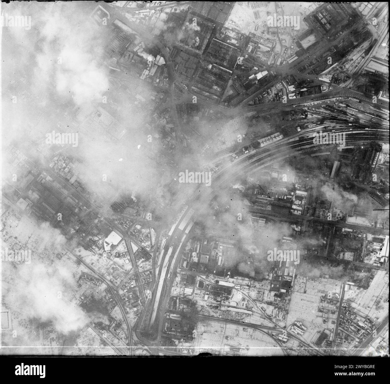 ROYAL AIR FORCE: OPERATIONS BY THE PHOTOGRAPHIC RECONNAISSANCE UNITS, 1939-1945. - Vertical photographic-reconnaissance aerial taken over Stuttgart, Germany following the raid by aircraft of Bomber Command on the night of 20/21 February 1944, showing damaged industrial premises in the Feuerbach district. At top centre can be seen the heavily-damaged ignition equipment plant of Robert Bosch AG, while at centre right smoke still pours from the partially-destroyed works of Leichtmetallbau GmbH. , Royal Air Force, Expeditionary Air Wing, 904 Stock Photo