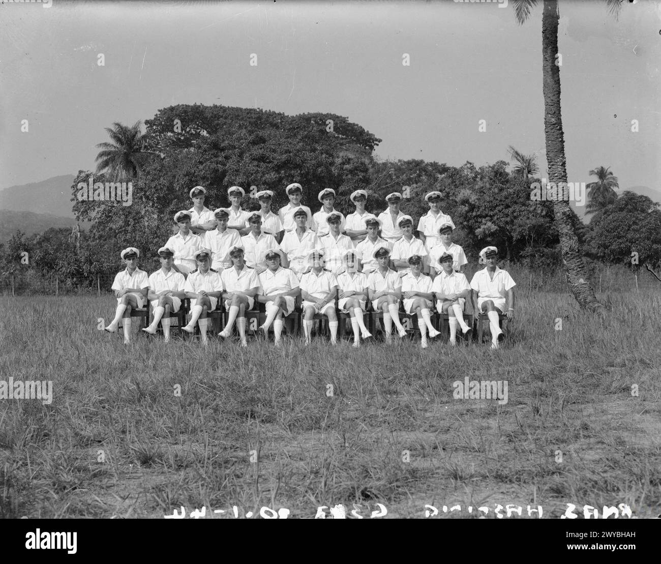 A NAVAL AIR STATION IN WEST AFRICAN BUSH. MARCH 1944, AT HMS SPURWING, ROYAL NAVAL AIR STATION IN SIERRA LEONE, ONCE A STRETCH OF UNTOUCHABLE BUSH. - The officers of HMS SPURWING. Back row, left to right: Sub Lieut (A) D Kirby, RNVR, Sub Lieut (A) J W Munby, RNVR; Pay Sub Lieut F C Lancaster, RNVR; Midshipman (A) R Collins, RNVR; Sub Lieut (A) N O Turnbull, RNZNVR, Sub Lieut (A) N Donkin, RNZNVR; Sub Lieut (A) G E Povey, RNVR. Middle Row, left to right: Sub Lieut (A) B A W Savage, RNVR, Sub Lieut (A) S H Boustred, RNVR; Mr A J Walters, Warrant Electrician, RN; Sub Lieut (A) N R Hamilton, RNVR; Stock Photo