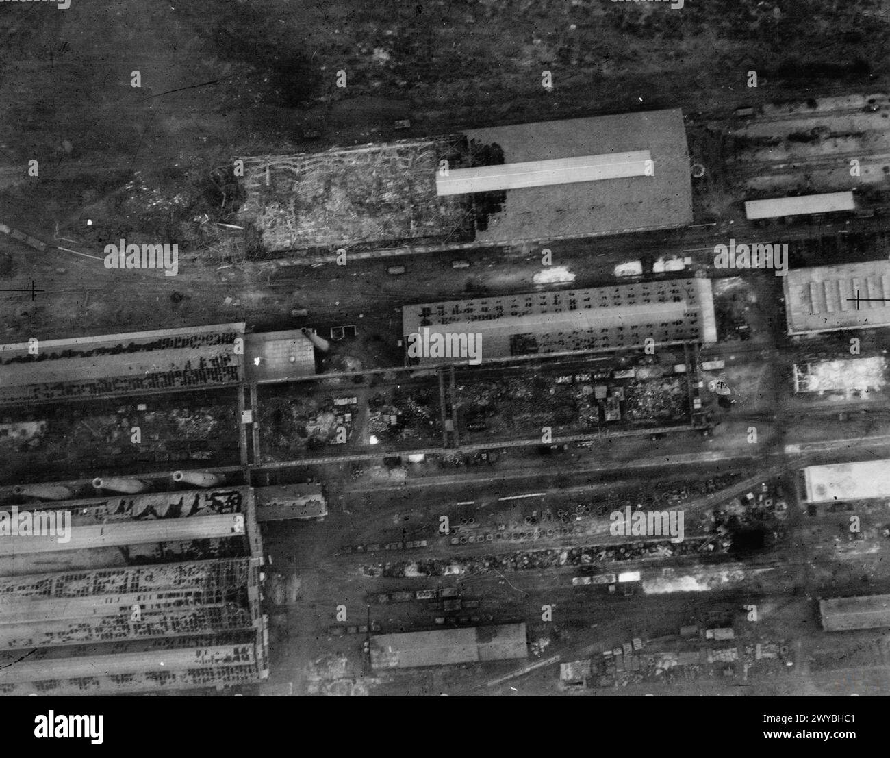 Reconnaissance Group Commander A low-level reconnaissance photograph shows blast-damaged buildings at ...