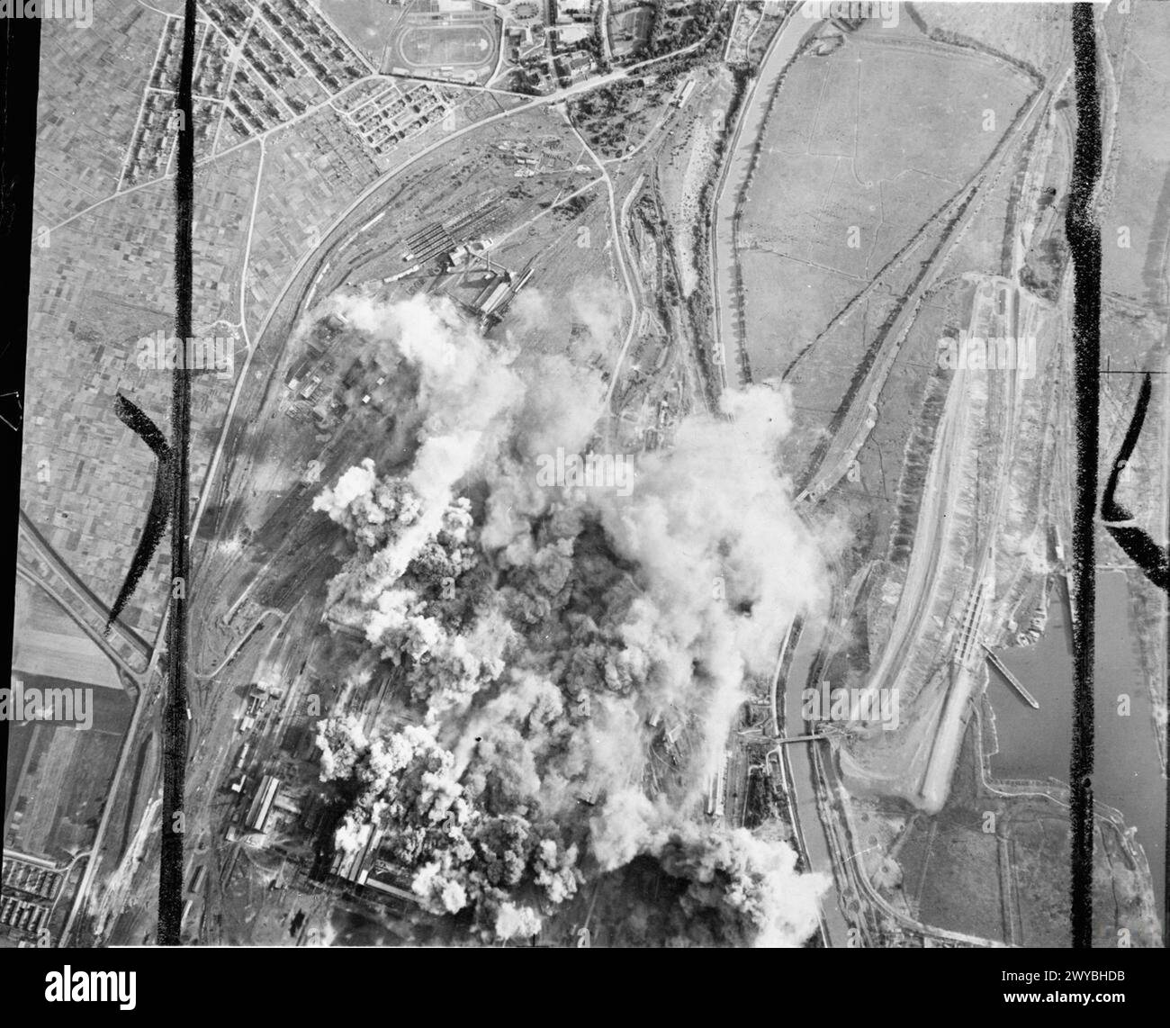 ROYAL AIR FORCE: 2ND TACTICAL AIR FORCE, 1943-1945. - Smoke from exploding bombs rises from the Colombelles steel works, east of Caen, during the attack by No. 2 Group on this German strongpoint. 48 North American Mitchells and 24 Douglas Bostons dropped a mixed load of 284 500-lb bombs and 48 1,000-lb bombs on the target. The Orne river can be seen to the right. , Royal Air Force, 2 Group, Royal Air Force, Maintenance Unit, 201 Stock Photo