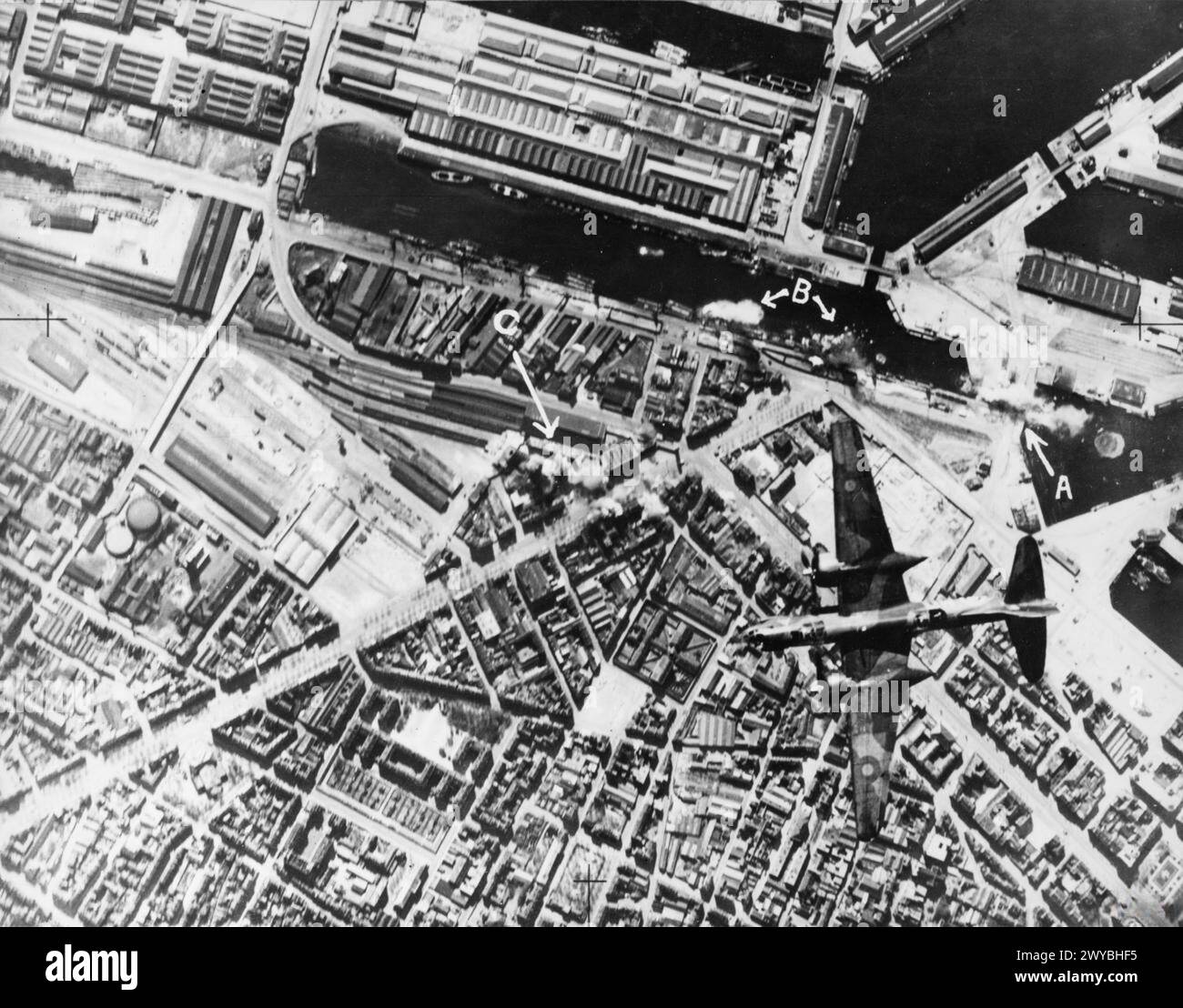 ROYAL AIR FORCE BOMBER COMMAND, 1942-1945. - Annotated vertical aerial photograph taken during a daylight attack by 12 Douglas Boston Mark IIIs of No. 226 Squadron RAF on shipping in le Havre, France. A Boston flys over the docks as bombs explode on the dock gates ( 'A'), among barges in the Bassin Vauban ('B') and on buildings by the centtral railway station ('C'). , Royal Air Force, Group, 226, Royal Air Force, 2 Group Stock Photo