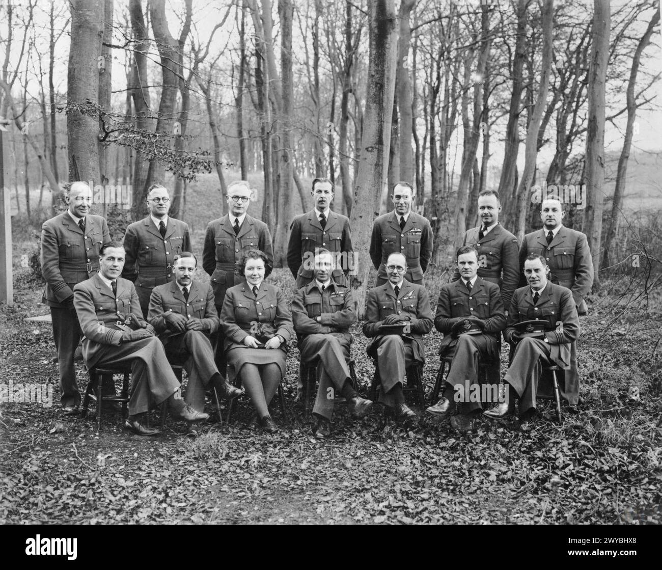 PHOTOGRAPHY DURING THE SECOND WORLD WAR - A group of Bomber Command Photographic Officers, led by Group Captain F C Sturgiss OBE.Standing left to right:Squadron Leader E King, Squadron Leader J E Brown, Squadron Leader J Jameson, Flight Lieutenant J S Cabot, Squadron Leader L Mant, Squadron Leader A S Archer (from Canada), Pilot Officer R G Cleave.Sitting left to right:Squadron Leader H W Lees, Squadron Leader L Hardy, Station Officer T Hamilton-Jones, Group Captain F C Sturgiss, Squadron Leader F L Wills, Flight Lieutenant J J McCloskey, Squadron Leader J E Archibald. , Royal Air Force Stock Photo