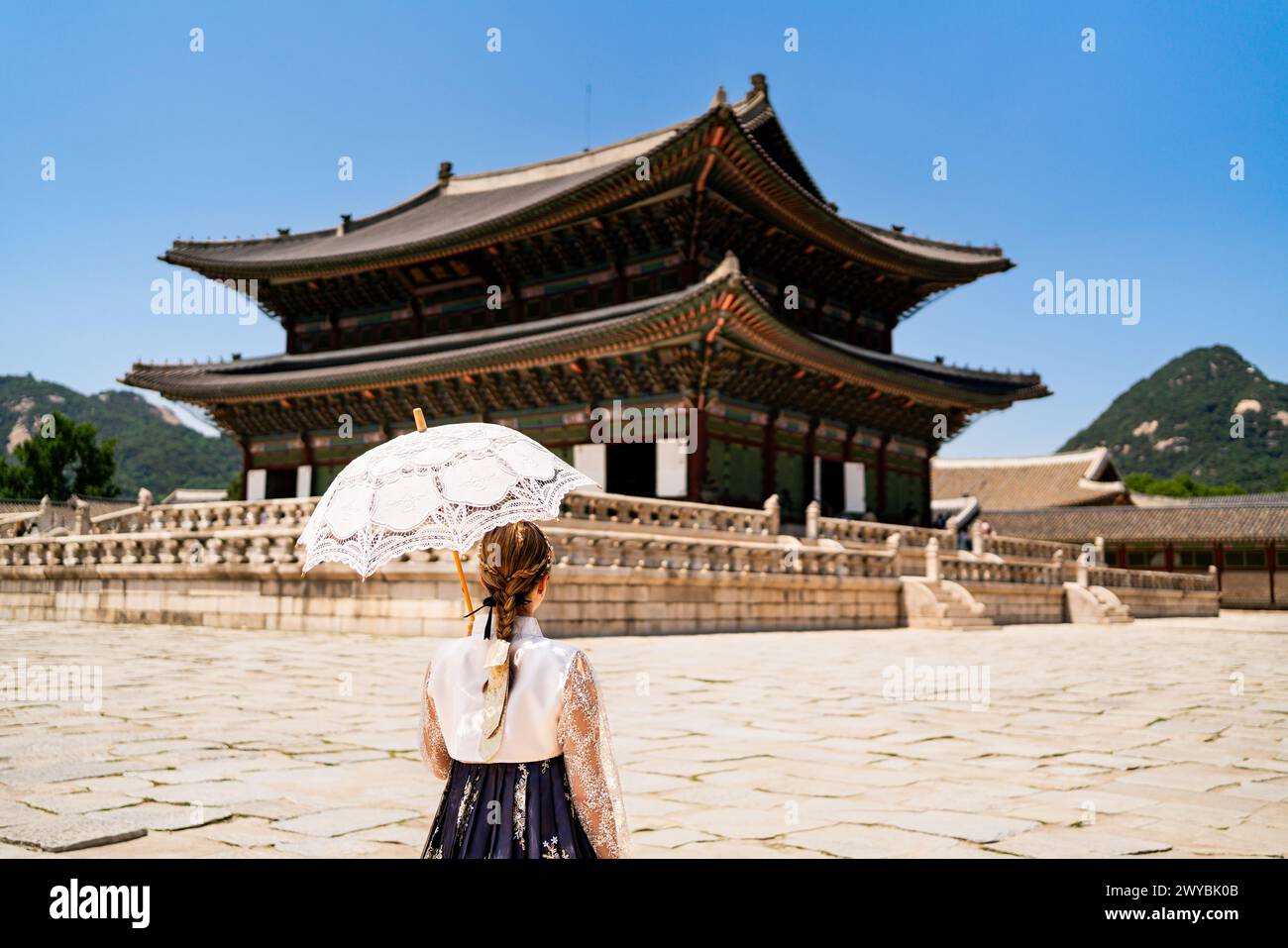 Seoul, South Korea. Gyeongbokgung Palace. Woman in hanbok, traditional Korean dress, costume and clothes. Travel tour and tourism at landmark. Stock Photo